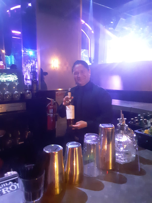 Smiling bartender at Chelsea NYC event space.