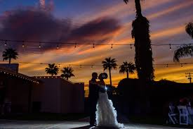 Embracing couple at wedding in Southern Arizona with colorful sunset sky.
