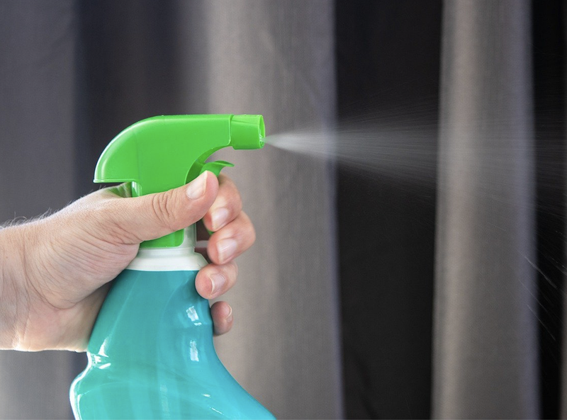 spray bottle spraying cleaning fluid