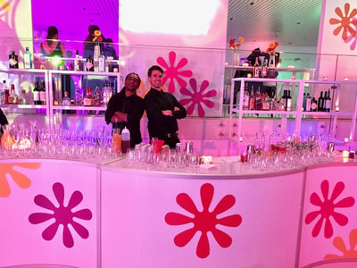Tapuz bartenders smiling at bar at midtown west manhattan new york city venue.