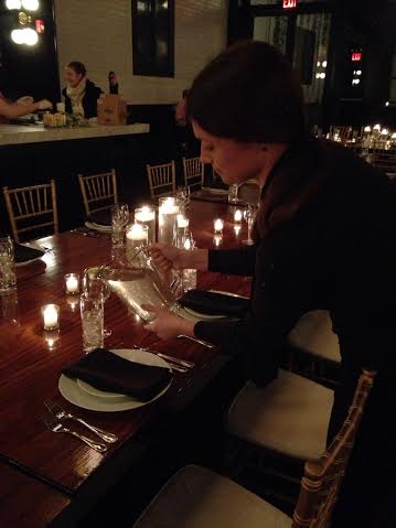 Server setting table for catered Brooklyn NYC event.