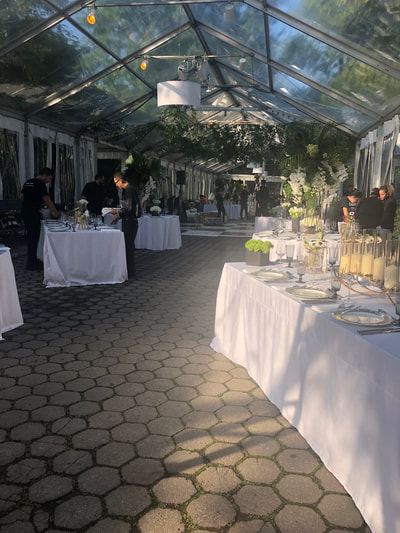 Servers setting up tables before an Manhattan event.