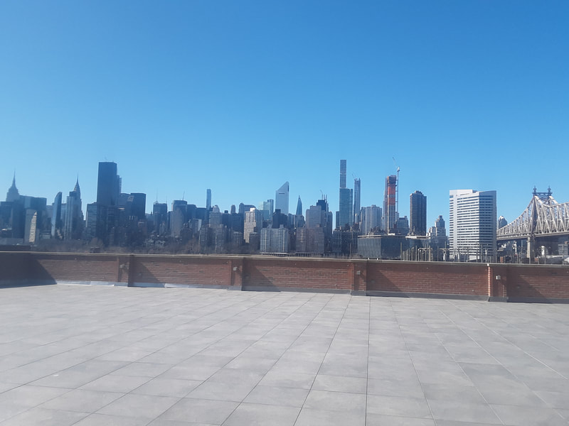 View of the Manhattan skyline with blue sky, from Bordone event space in Queens, New York City.